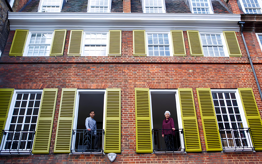 Aaron Cezar and Delfina Entrecanles stand at the windows of the Delfina Foundation building