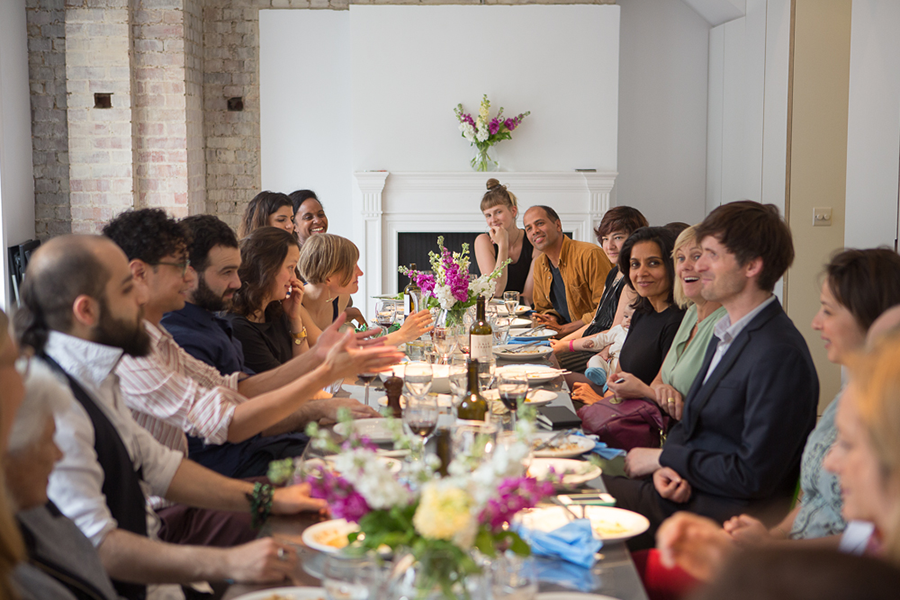 A group sits at a dinner table for the Delfina Foundation Family Lunch